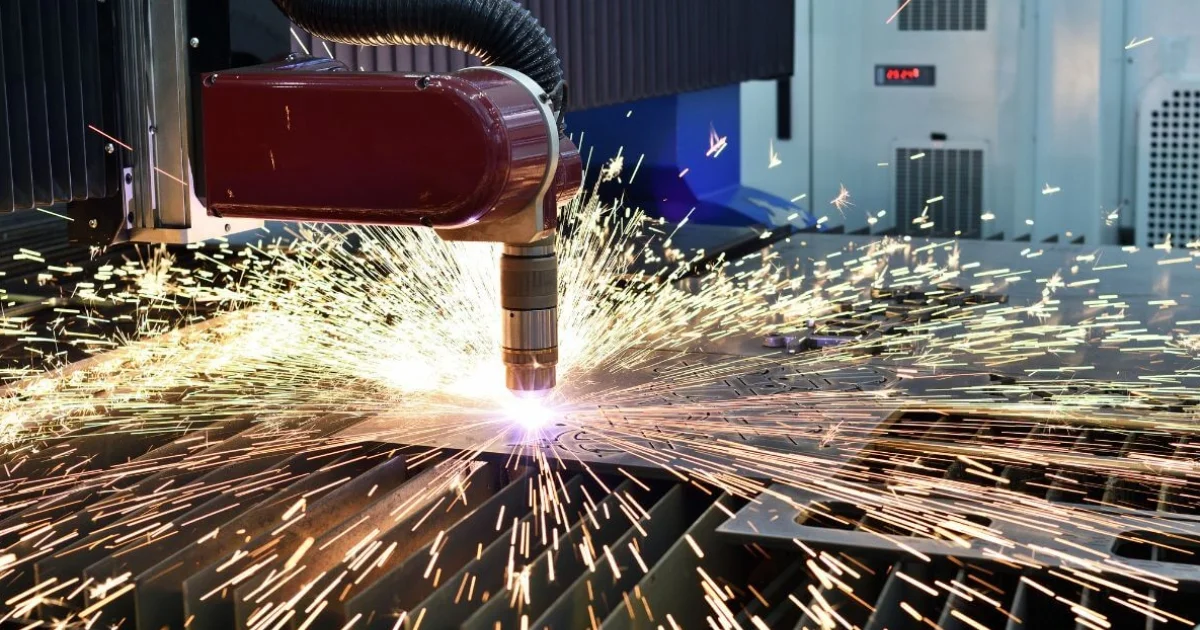 Plasma cutting machine generating sparks while slicing metal